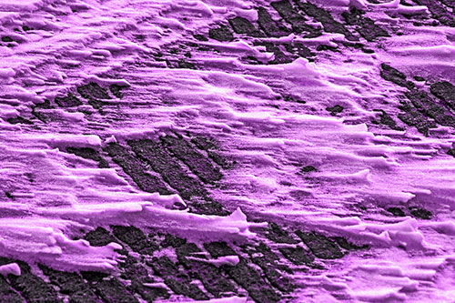 Snow Drifts Atop Rigid Pavement (Purple Tone Photo)