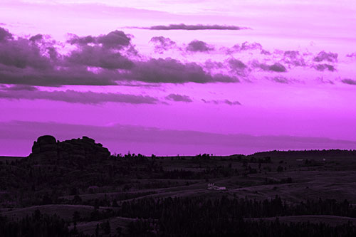 Sunrise Over Rock Formations On The Horizon (Purple Tone Photo)