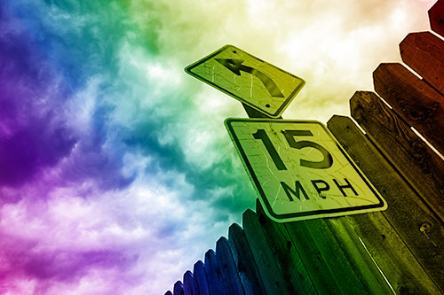 Left Turn Speed Limit Sign Beside Wooden Fence (Rainbow Shade Photo)