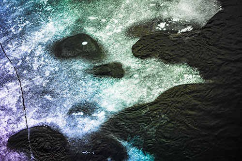 Disintegrating Ice Face Melting Among Flowing River Water (Rainbow Tint)