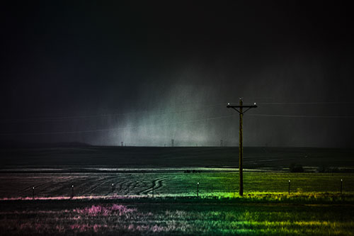 Distant Thunderstorm Rains Down Upon Powerlines (Rainbow Tint Photo)
