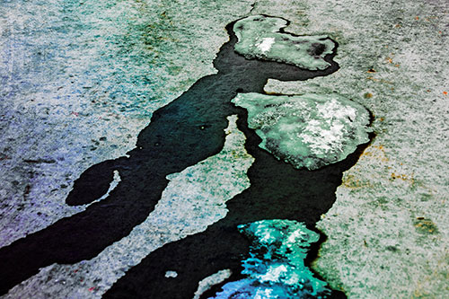 Melting Ice Puddles Forming Water Streams (Rainbow Tint Photo)