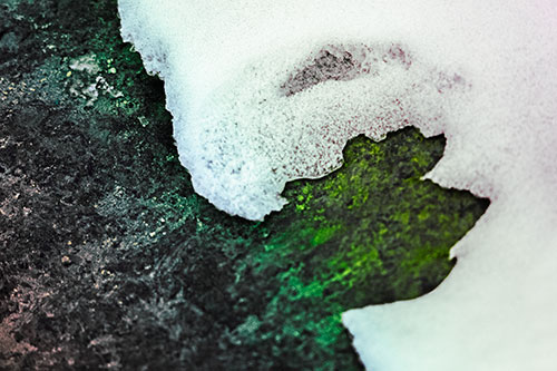 Screaming Snow Face Slowly Melting Atop Rock Surface (Rainbow Tint Photo)