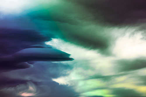 Smooth Cloud Sails Along Swirling Formations (Rainbow Tint Photo)
