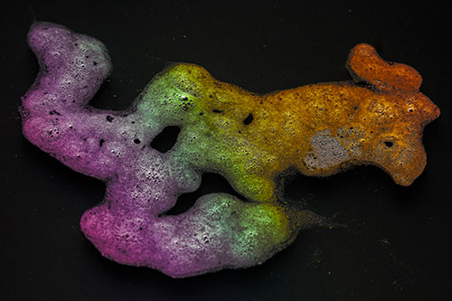 Sorrow Morphing Bubble Face Floating Above Soil (Rainbow Tint)