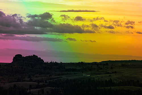 Sunrise Over Rock Formations On The Horizon (Rainbow Tint Photo)