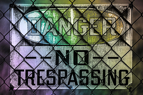 Dirty Danger No Trespassing Sign Behind Chain Link Fence (Rainbow Tone)
