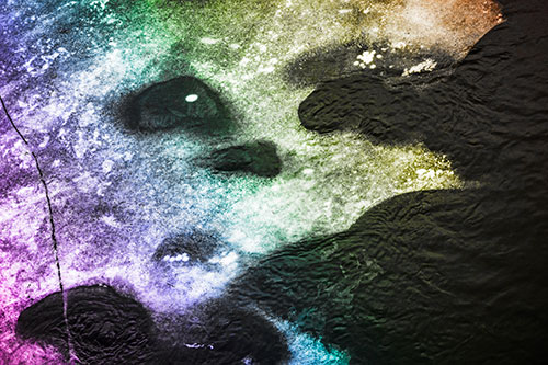 Disintegrating Ice Face Melting Among Flowing River Water (Rainbow Tone)