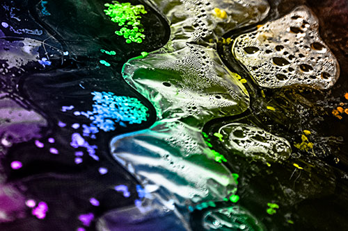 Distorted Plastic Bubble Face Floating Atop Water (Rainbow Tone)