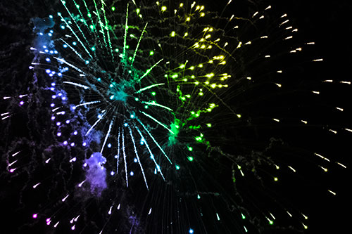Multiple Firework Explosions Send Light Orbs Flying (Rainbow Tone Photo)