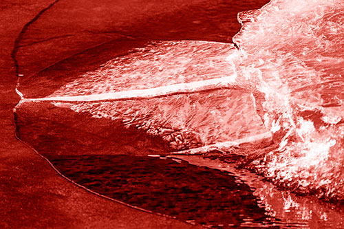 Abstract Ice Sculpture Forms Atop Frozen River (Red Shade Photo)