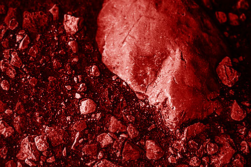 Alien Skull Rock Face Emerging Atop Dirt Surface (Red Shade Photo)