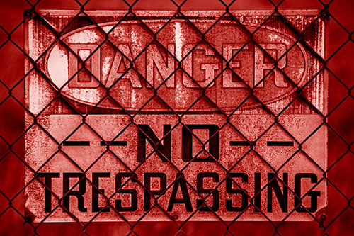Dirty Danger No Trespassing Sign Behind Chain Link Fence (Red Shade)