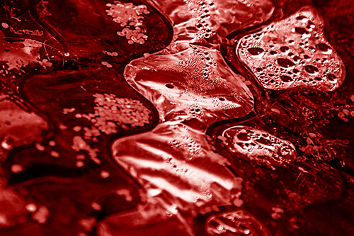 Distorted Plastic Bubble Face Floating Atop Water (Red Shade)