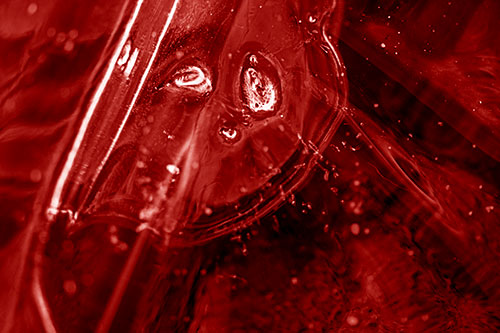 Frozen Unhappy Frowning Distorted River Ice Face (Red Shade Photo)
