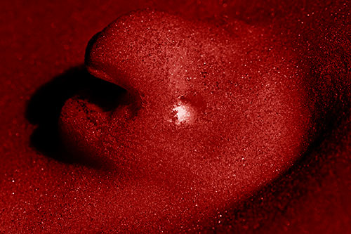 Glowing Eyed Snow Face Emerges Above Soil (Red Shade)