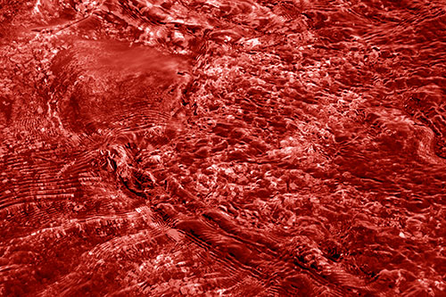 Large Algae Rock Creating River Water Ripples (Red Shade Photo)