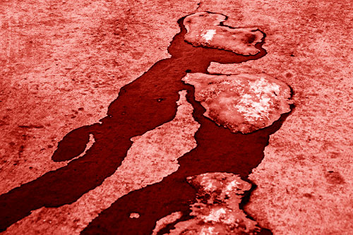 Melting Ice Puddles Forming Water Streams (Red Shade Photo)