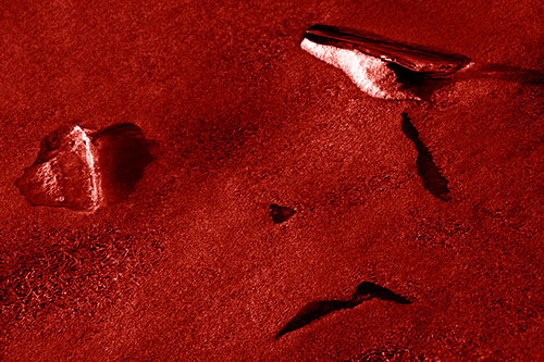 Sad Teardrop Ice Face Appears Atop Frozen River (Red Shade Photo)