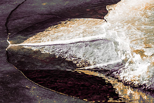 Abstract Ice Sculpture Forms Atop Frozen River (Red Tint Photo)
