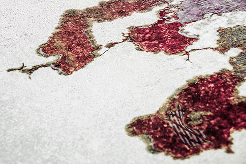 Creeping Water Puddle Across Concrete Pavement (Red Tint)