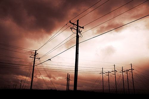 Crossing Powerlines Beneath Rainstorm (Red Tint Photo)