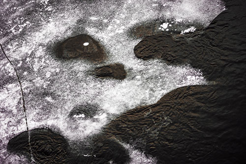 Disintegrating Ice Face Melting Among Flowing River Water (Red Tint)