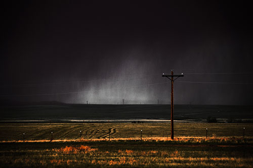 Distant Thunderstorm Rains Down Upon Powerlines (Red Tint Photo)