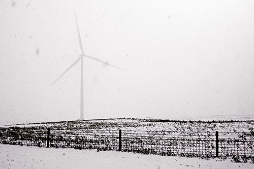 Fenced Wind Turbine Among Blowing Snow (Red Tint Photo)