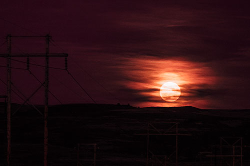 Full Moonrise Behind Mountain (Red Tint Photo)