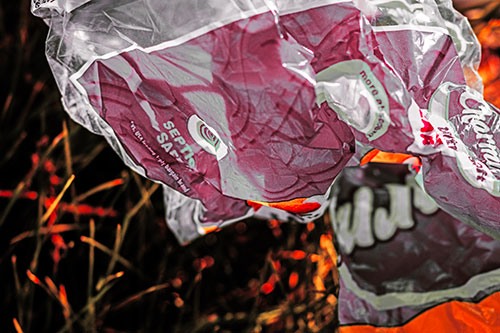 Growling Plastic Charmin Bag Among Grass (Red Tint)