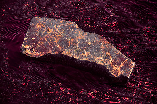 Massive Rock Atop Riverbed (Red Tint Photo)