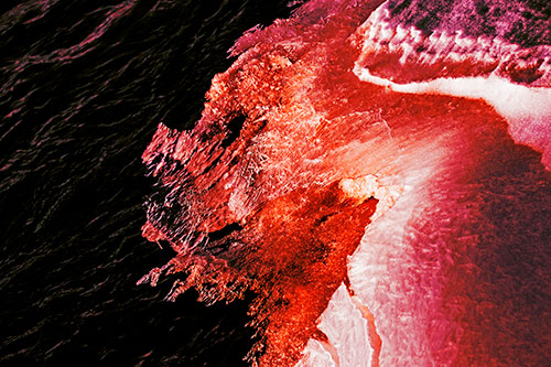 Melting Ice Face Creature Atop River Water (Red Tint)