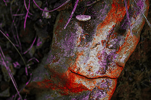 Smirking Battered Rock Face (Red Tint Photo)
