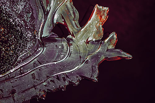 Smooth Ice Face Creature Hanging Above River Shoreline (Red Tint)