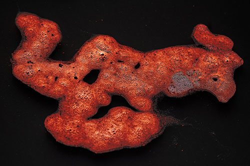 Sorrow Morphing Bubble Face Floating Above Soil (Red Tint)
