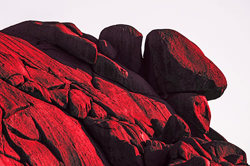 Sunlight Casting Shadows On Mountain Of Rocks (Red Tint Photo)