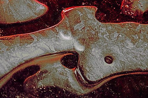 Swirling Frozen Smiling Bubble Eyed River Ice Face (Red Tint)