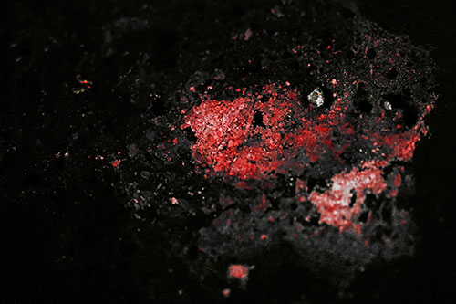 Wide Eyed Oil Demon Face Floating Atop Water (Red Tint)