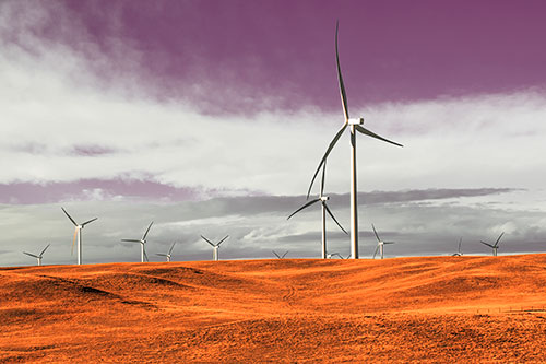 Wind Turbine Cluster Overtaking Hilly Horizon (Red Tint Photo)