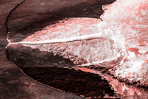 Abstract Ice Sculpture Forms Atop Frozen River (Red Tone Photo)