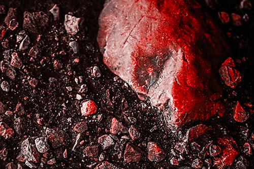 Alien Skull Rock Face Emerging Atop Dirt Surface (Red Tone Photo)