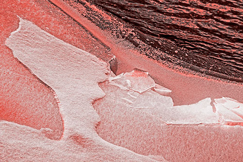 Broken Cracked Ice Along Shoreline (Red Tone)