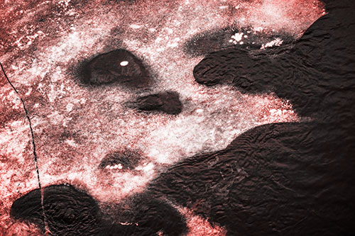 Disintegrating Ice Face Melting Among Flowing River Water (Red Tone Photo)