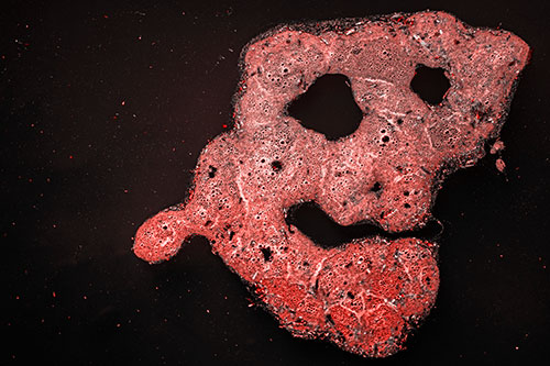 Droopy Smiling Bubble Face Floating Above Soil (Red Tone)