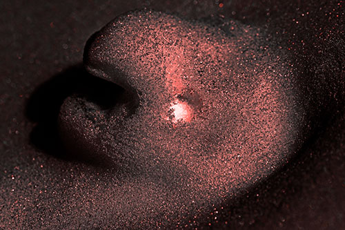 Glowing Eyed Snow Face Emerges Above Soil (Red Tone)
