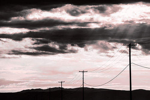 Powerline Silhouette Entering Mountain Range (Red Tone Photo)