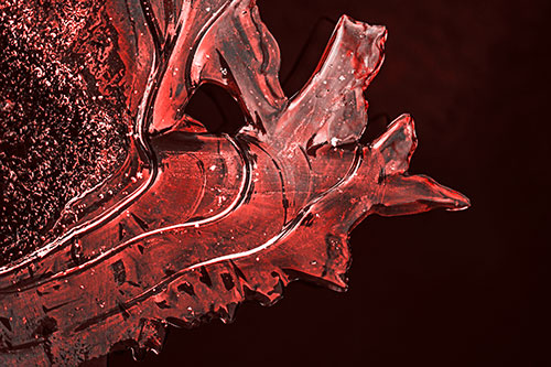 Smooth Ice Face Creature Hanging Above River Shoreline (Red Tone)