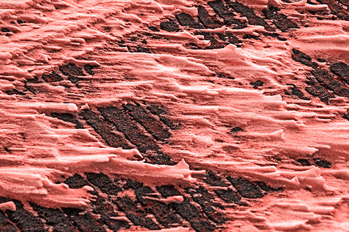 Snow Drifts Atop Rigid Pavement (Red Tone Photo)