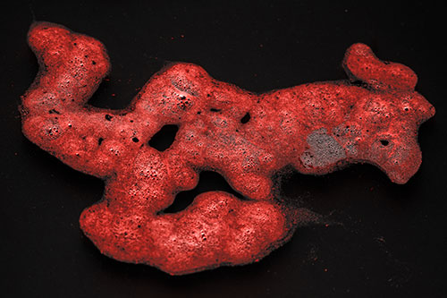 Sorrow Morphing Bubble Face Floating Above Soil (Red Tone)